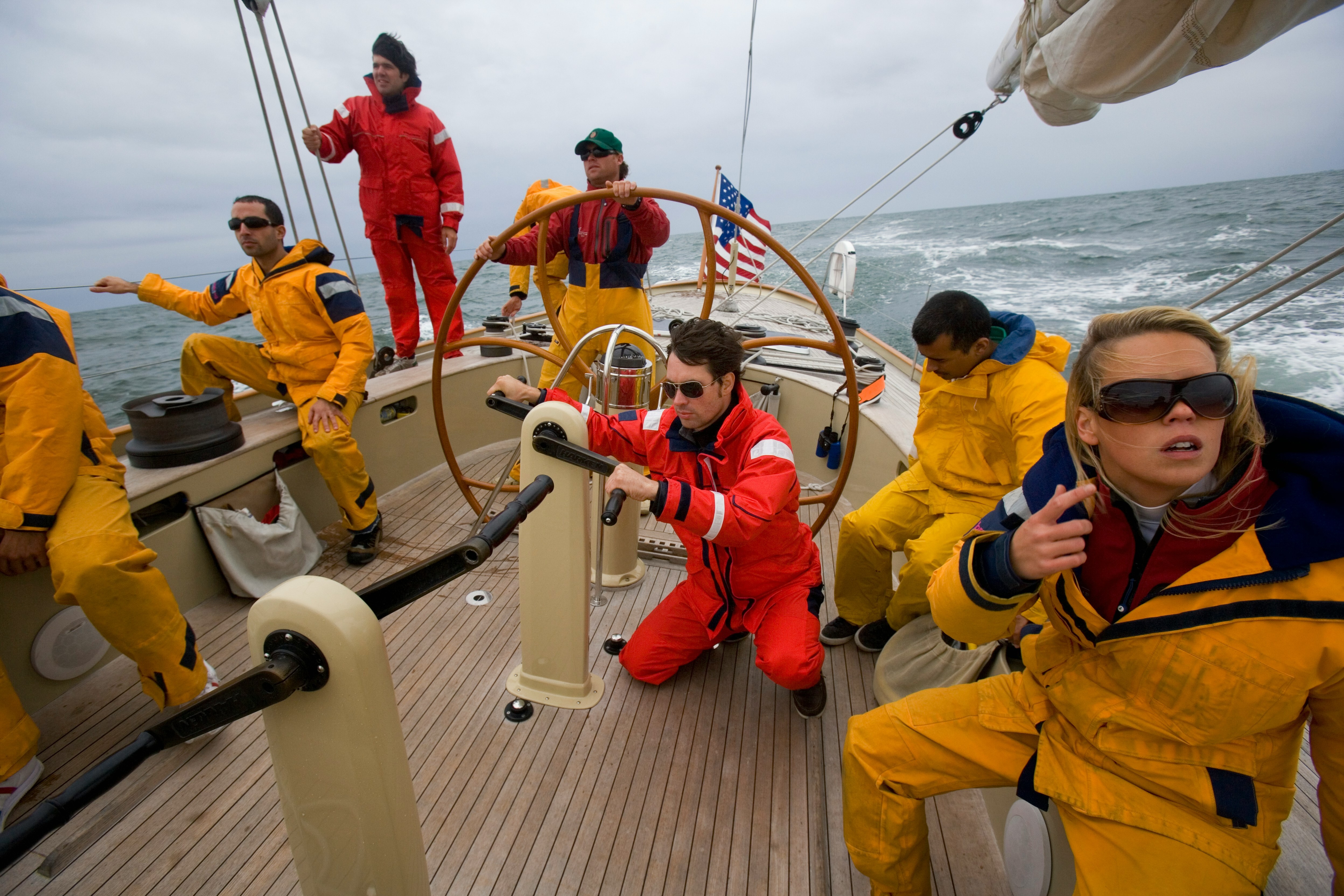 Sailing team working together on a boat
