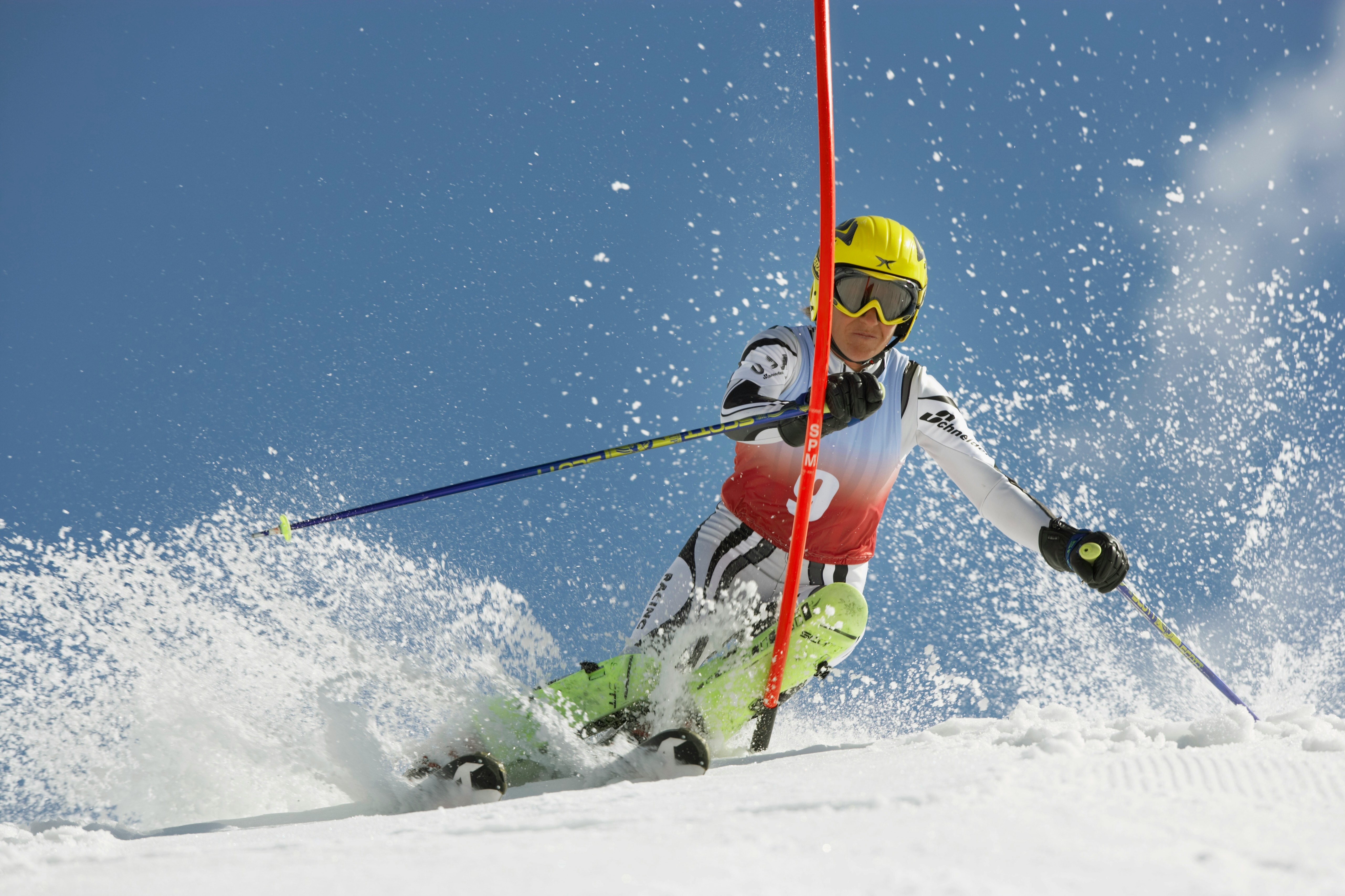 Slalom skier racing through gates